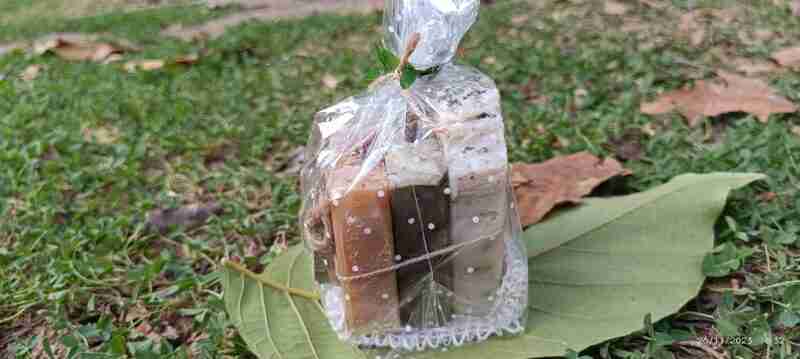 Jabones artesanales envueltos sobre hojas y césped.