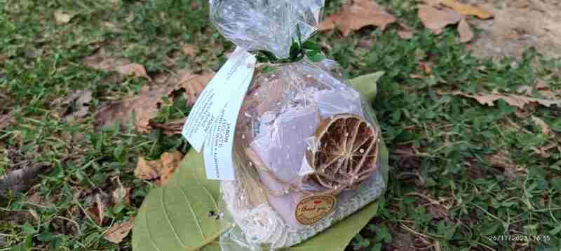 Jabón artesanal envuelto con hoja, sobre césped.
