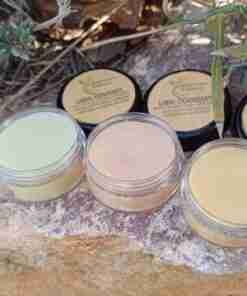 Bálsamos labiales naturales sobre roca al aire libre.